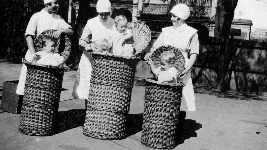 Historical image with nurses and babies in baskets