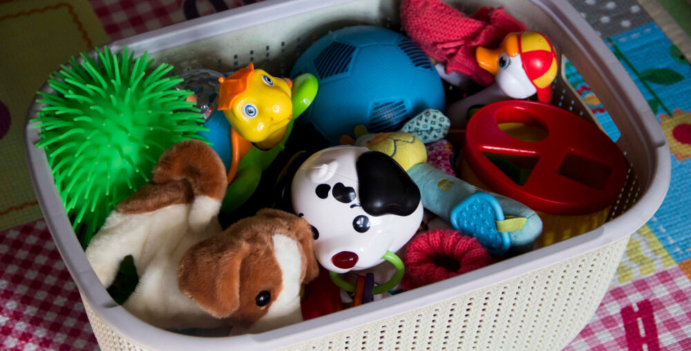 Plastic tub full of different toys