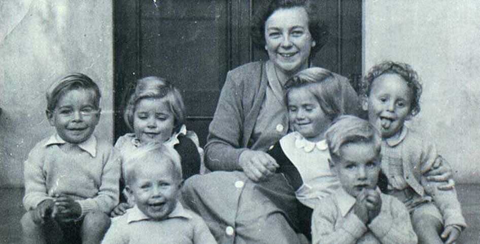 Historical picture of lady sitting with six children