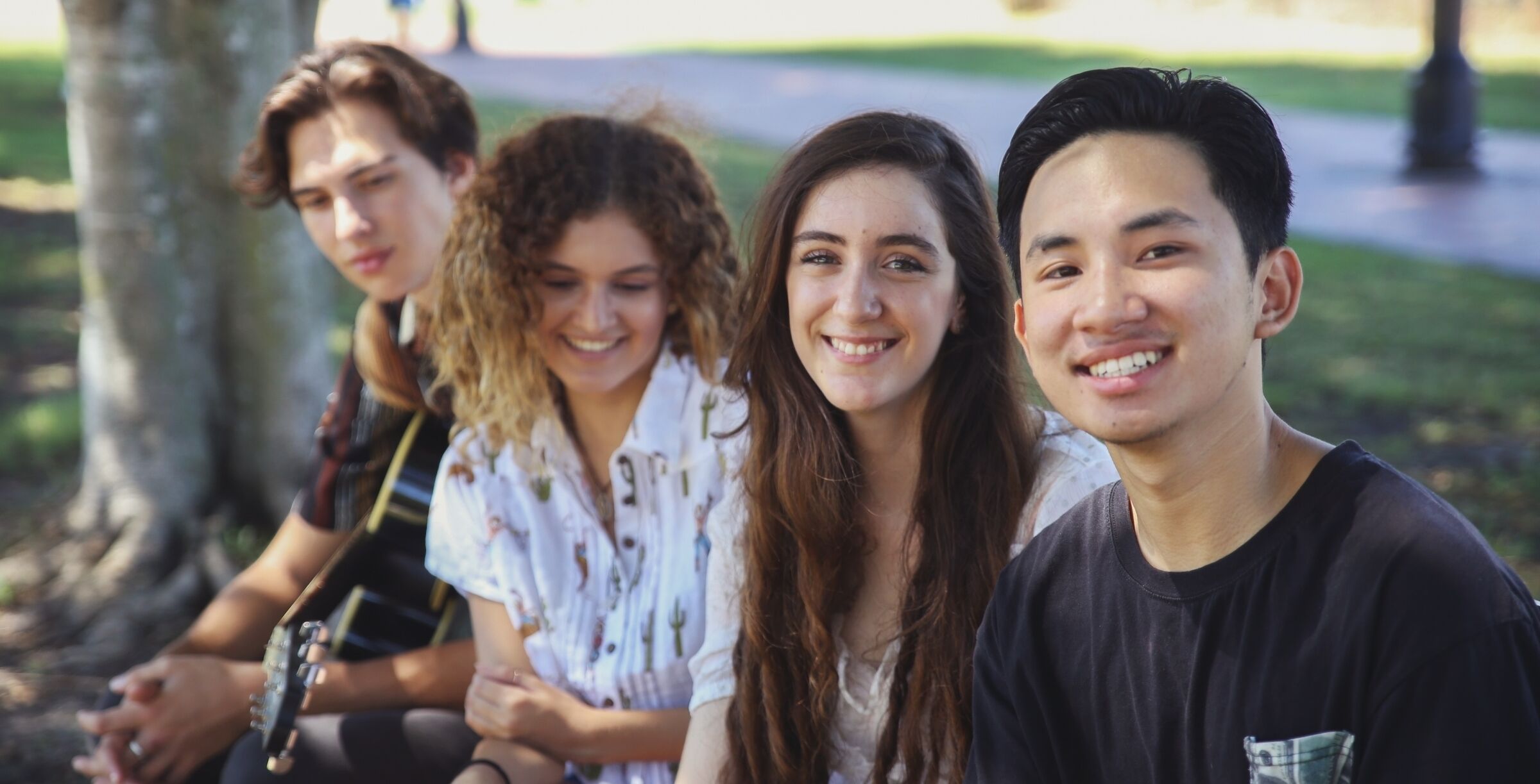 Group of four adolescents smiling