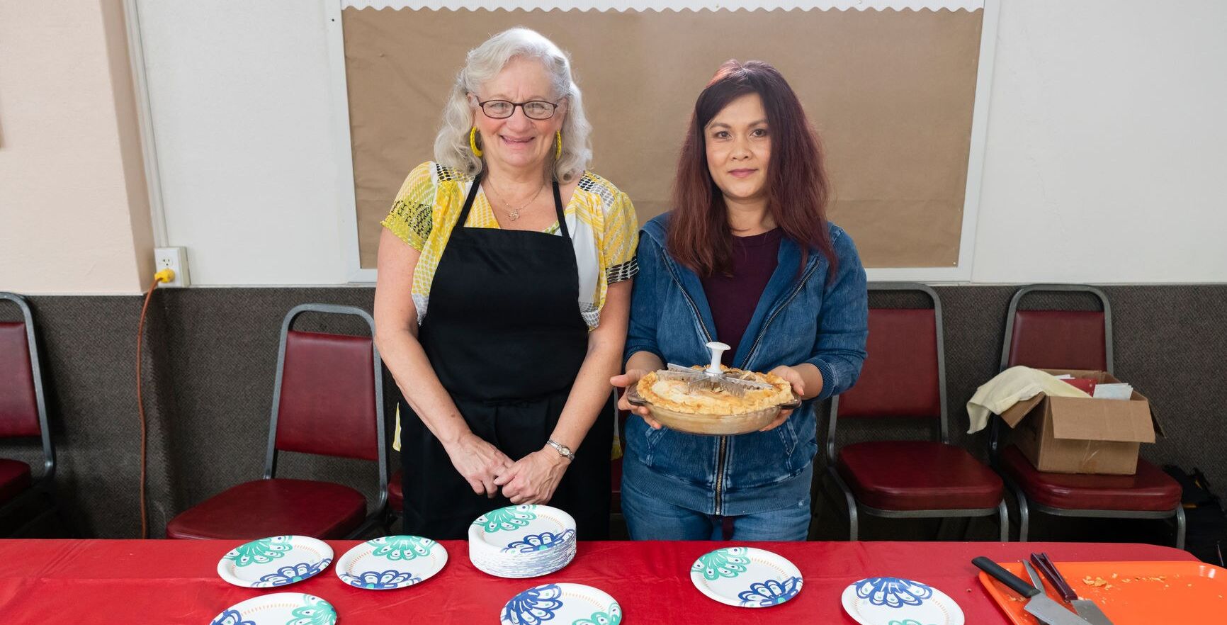 Two women serving dessert