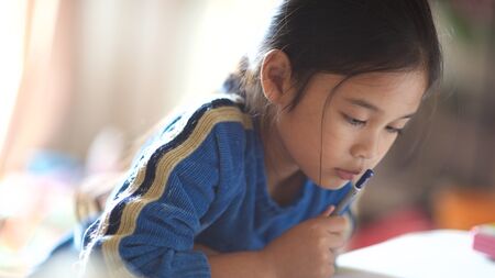 Young girl reading schoolwork
