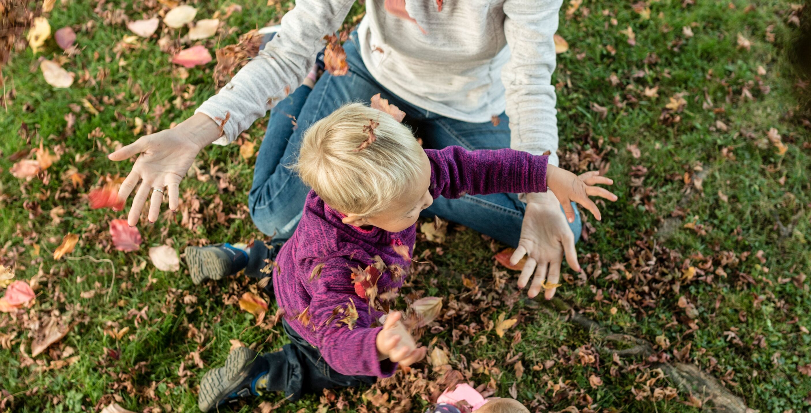 Woman playing with children on grass