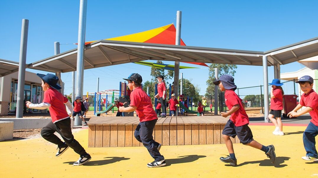 Kids running outside in school playground