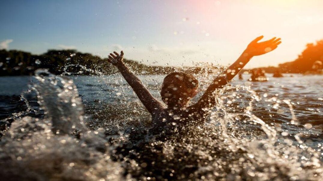Child splashing in lake