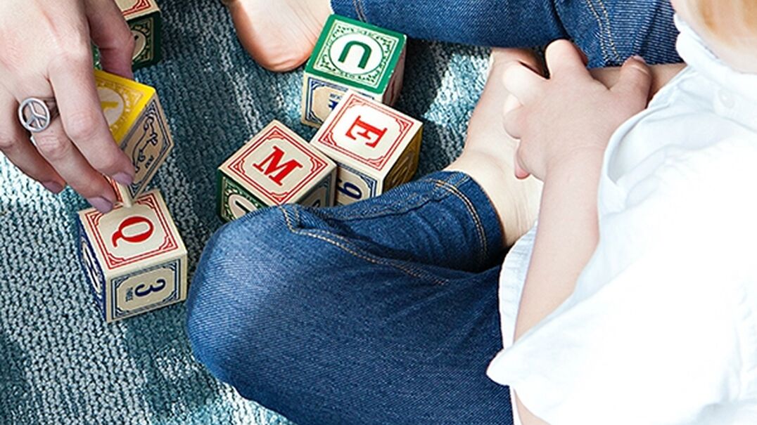 Young child playing with alphabet blocks