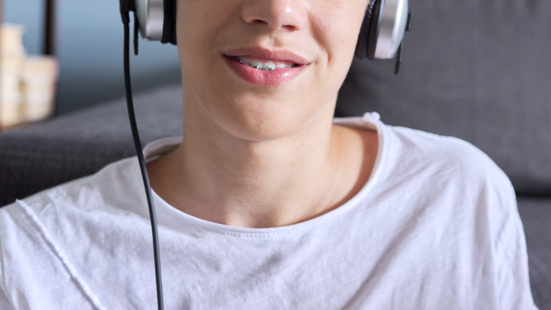 Young boy with braces wearing headphones