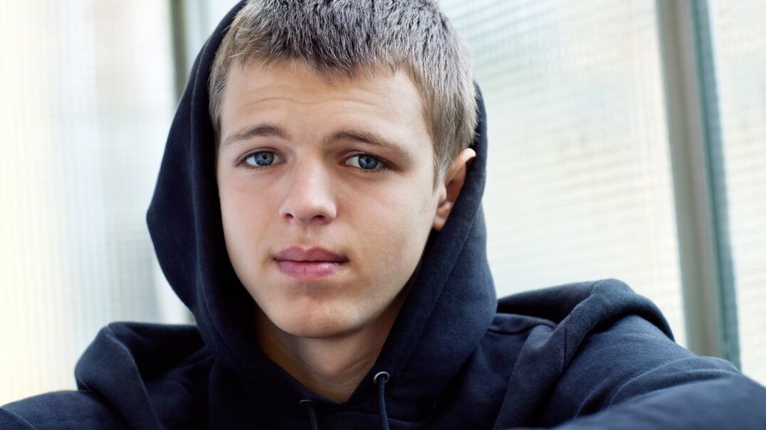 teenage boy with neutral facial expression