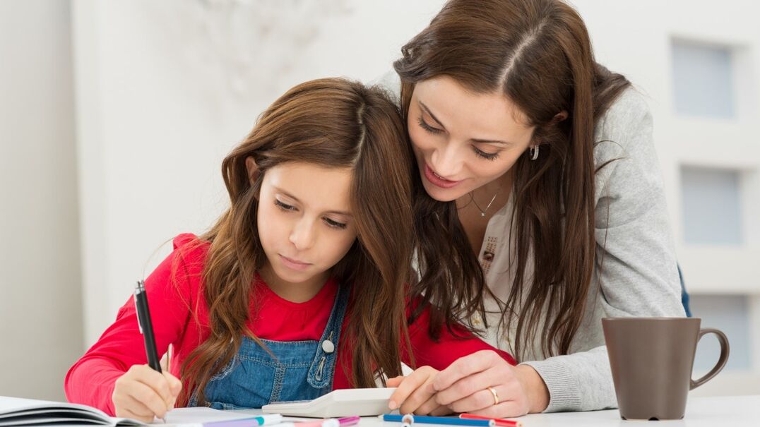 mother helping daughter with school work