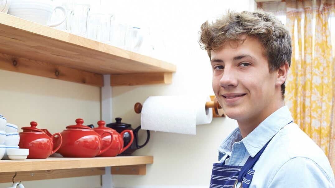 young boy in kitchen smiling